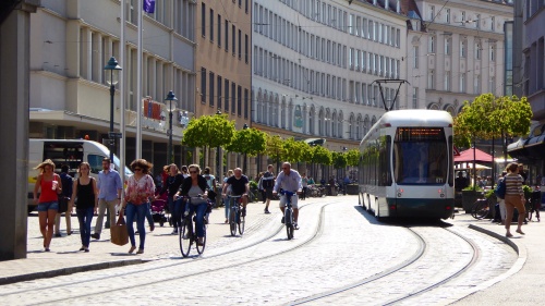 Bicycles share the road with trams, buses and pedestrians.